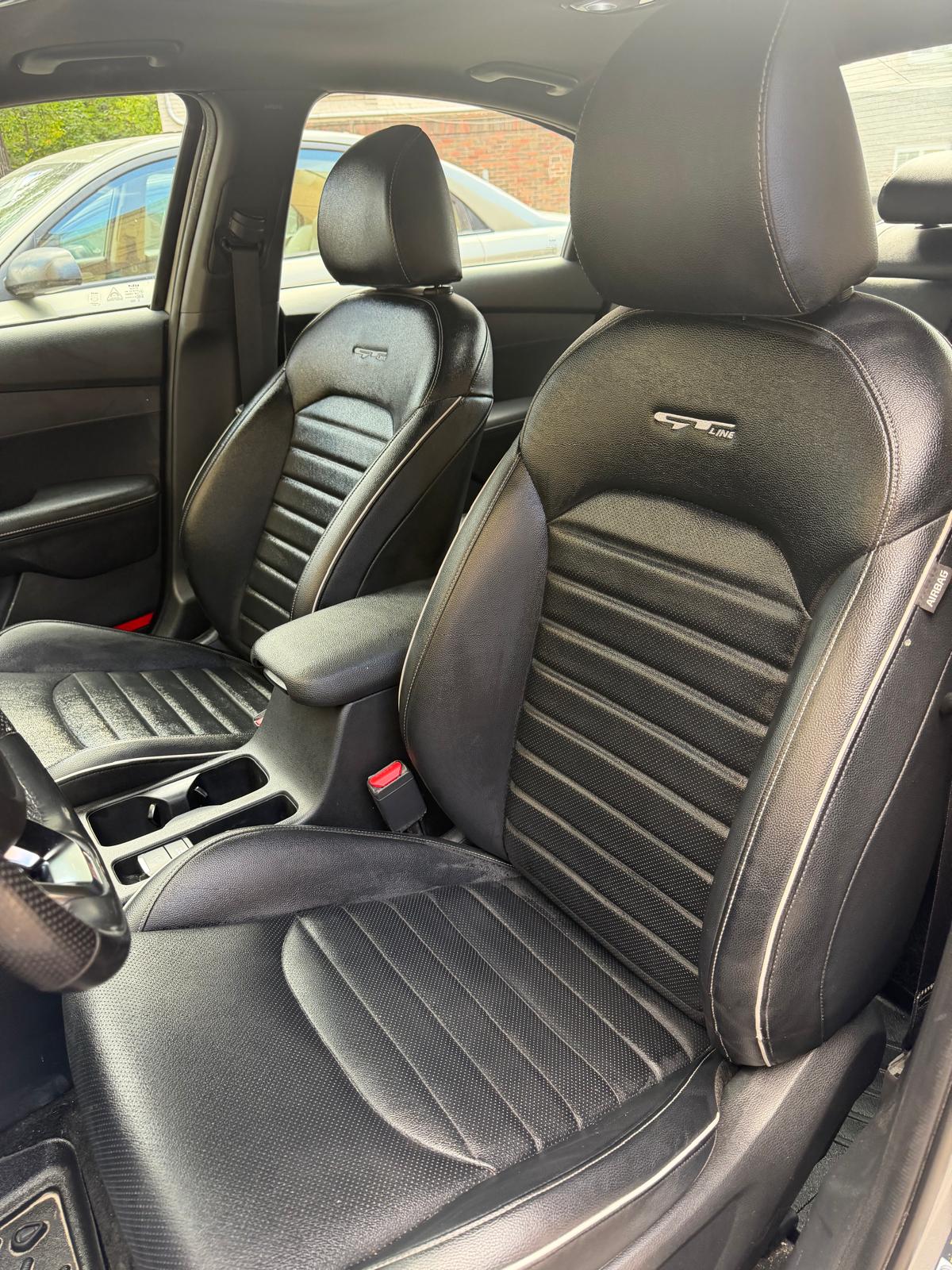 Black leather front seats after detailing
